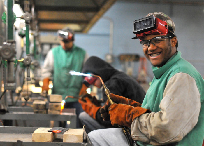 Manufacturing student holding blowtorch in class. Credit: Central Carolina Community College (CCCC)